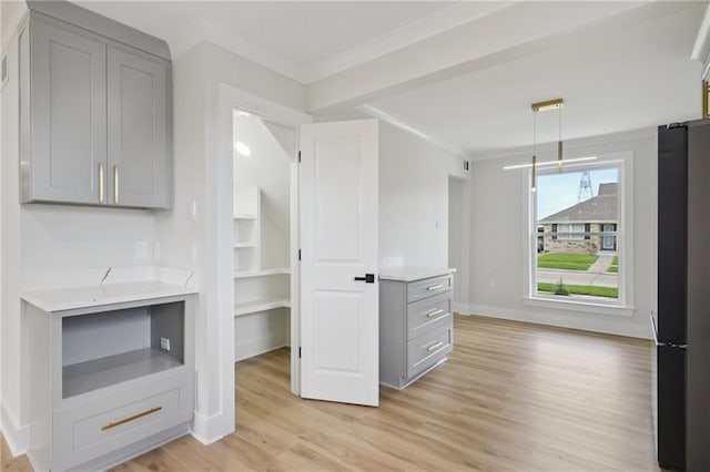 3101 Lake Trail Dr, Metairie, LA 70003 - kitchen featuring gray cabinets, freestanding refrigerator, crown molding, light wood-type flooring, and hanging light fixtures