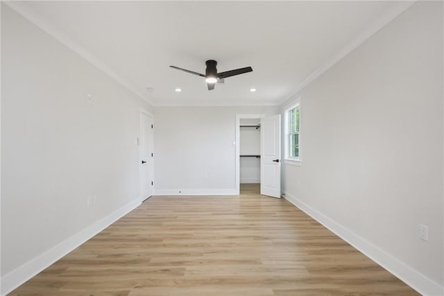 3101 Lake Trail Dr, Metairie, LA 70003 - unfurnished bedroom with crown molding, recessed lighting, light wood-style floors, a walk in closet, and ceiling fan