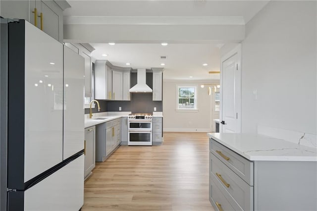 3101 Lake Trail Dr, Metairie, LA 70003 - kitchen with white appliances, wall chimney range hood, gray cabinets, crown molding, and recessed lighting
