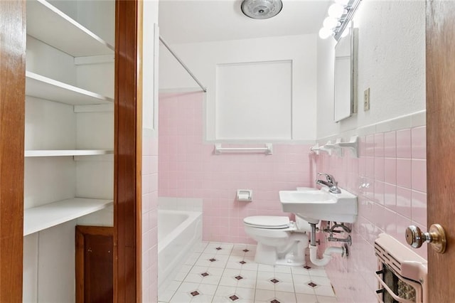 2417 Maine Ave, Metairie, LA 70003 - bathroom with tile patterned flooring, tile walls, wainscoting, and bathing tub / shower combination
