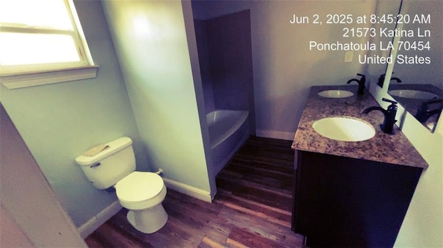 21573 Katina Ln, Ponchatoula, LA 70454 - full bathroom with wood finished floors, double vanity, and a tub to relax in