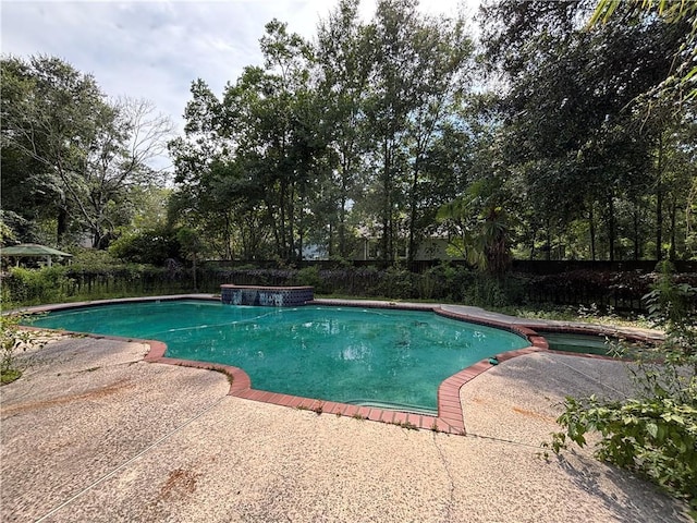 72075 Gum St, Abita Springs, LA 70420 - view of swimming pool featuring a patio area, a pool with connected hot tub, and view of scattered trees