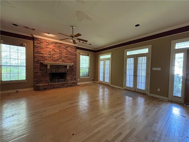 72075 Gum St, Abita Springs, LA 70420 - unfurnished living room with crown molding, wood finished floors, ceiling fan, and a brick fireplace
