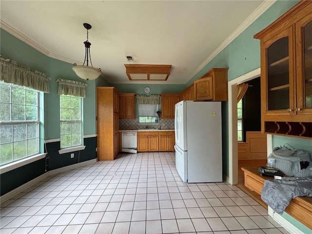 72075 Gum St, Abita Springs, LA 70420 - kitchen with white appliances, ornamental molding, decorative backsplash, brown cabinetry, and glass insert cabinets
