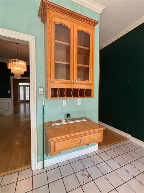 72075 Gum St, Abita Springs, LA 70420 - bar area with a chandelier, ornamental molding, and light tile patterned floors