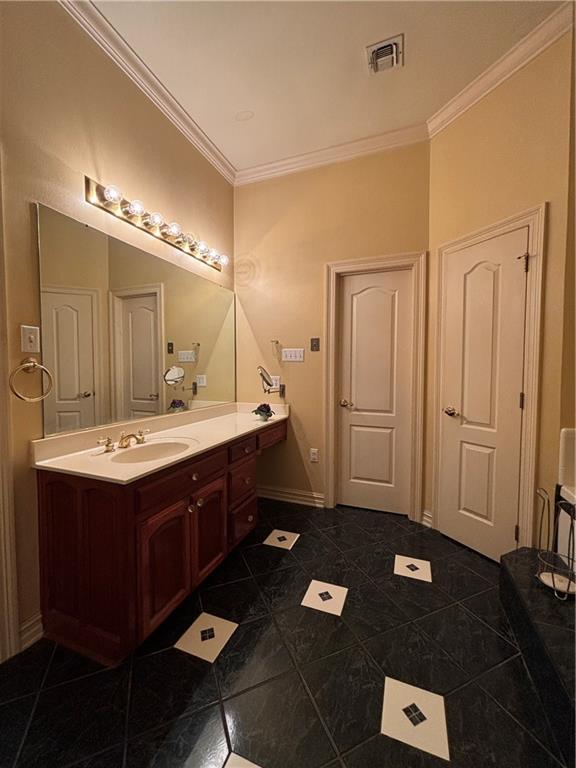 72075 Gum St, Abita Springs, LA 70420 - bathroom with ornamental molding, vanity, and tile patterned floors