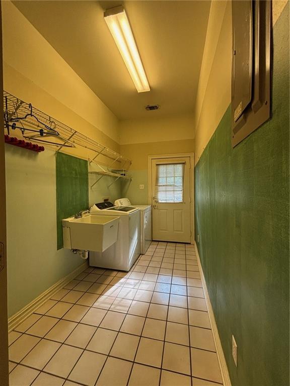 72075 Gum St, Abita Springs, LA 70420 - laundry area featuring washer and clothes dryer and light tile patterned floors