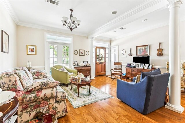 57 Beverly Garden Dr, Metairie, LA 70001 - living room featuring ornate columns, wood finished floors, ornamental molding, and a chandelier