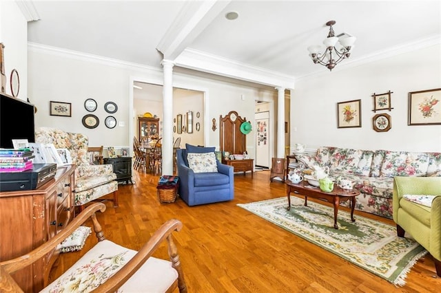 57 Beverly Garden Dr, Metairie, LA 70001 - living area with ornate columns, crown molding, wood finished floors, and a chandelier