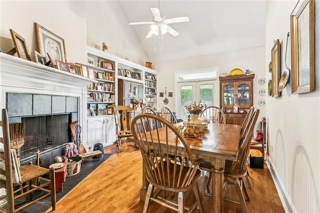 57 Beverly Garden Dr, Metairie, LA 70001 - dining space with a ceiling fan, wood finished floors, a fireplace, and high vaulted ceiling