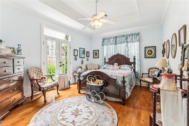 57 Beverly Garden Dr, Metairie, LA 70001 - bedroom with crown molding, wood finished floors, access to exterior, a tray ceiling, and french doors