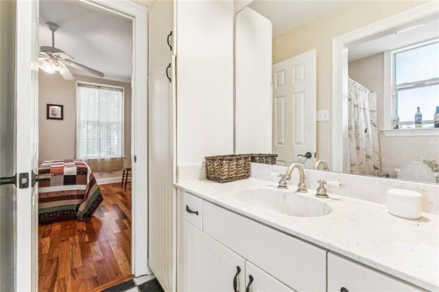 57 Beverly Garden Dr, Metairie, LA 70001 - ensuite bathroom with healthy amount of natural light, vanity, a ceiling fan, and wood finished floors