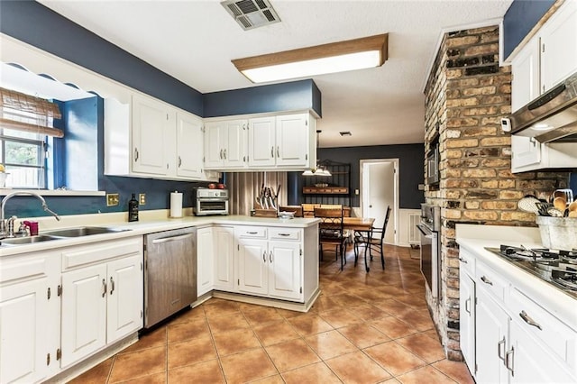 1369 Holiday Pl, New Orleans, LA 70114 - kitchen with stainless steel appliances, white cabinets, light countertops, a peninsula, and light tile patterned flooring