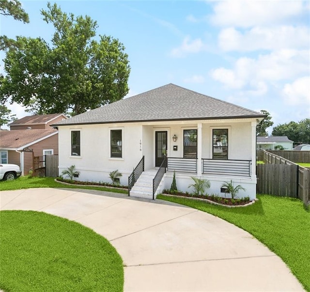 1916 Roosevelt Blvd, Kenner, LA 70062 - view of front of home featuring stucco siding, a shingled roof, a porch, and concrete driveway