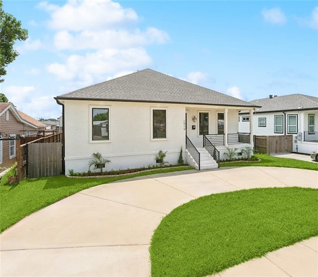 1916 Roosevelt Blvd, Kenner, LA 70062 - view of front of house featuring a porch, driveway, a shingled roof, and stucco siding