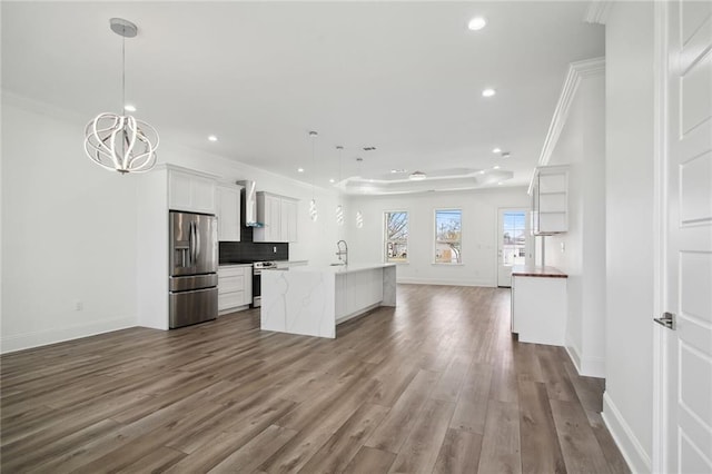 1916 Roosevelt Blvd, Kenner, LA 70062 - kitchen with stainless steel appliances, wall chimney range hood, open floor plan, recessed lighting, and a chandelier