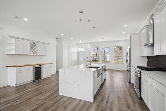 1916 Roosevelt Blvd, Kenner, LA 70062 - kitchen featuring beverage cooler, appliances with stainless steel finishes, open shelves, a kitchen island with sink, and recessed lighting