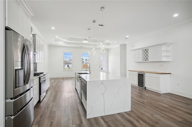 1916 Roosevelt Blvd, Kenner, LA 70062 - kitchen featuring stainless steel refrigerator with ice dispenser, range with gas stovetop, dark wood-type flooring, open shelves, and crown molding