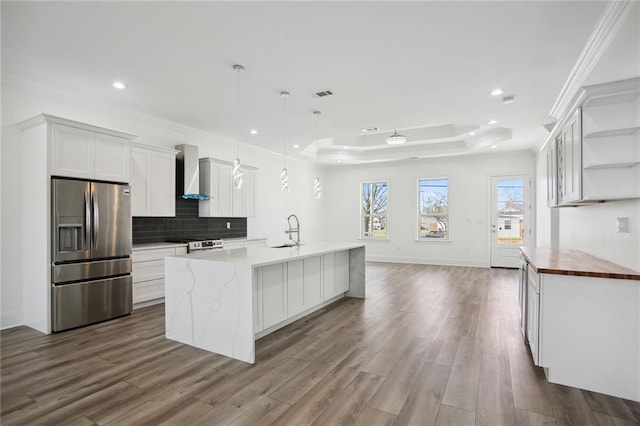 1916 Roosevelt Blvd, Kenner, LA 70062 - kitchen featuring stainless steel appliances, wall chimney range hood, open shelves, a raised ceiling, and recessed lighting