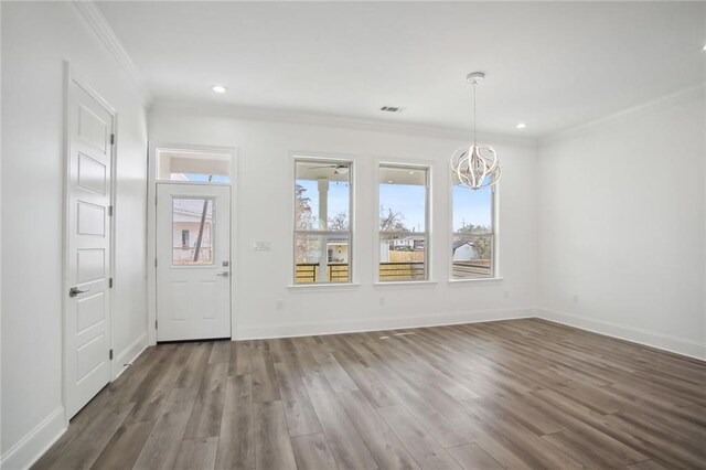 1916 Roosevelt Blvd, Kenner, LA 70062 - foyer with healthy amount of natural light, a chandelier, crown molding, wood finished floors, and recessed lighting