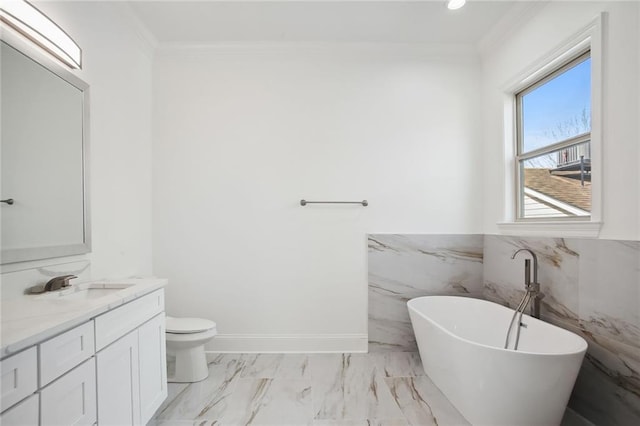 1916 Roosevelt Blvd, Kenner, LA 70062 - bathroom featuring vanity, a freestanding bath, crown molding, marble finish flooring, and wainscoting