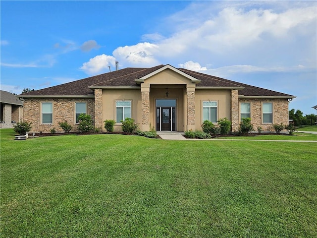181 Latigue Rd, Avondale, LA 70094 - view of front of property featuring a front yard, roof with shingles, and stucco siding