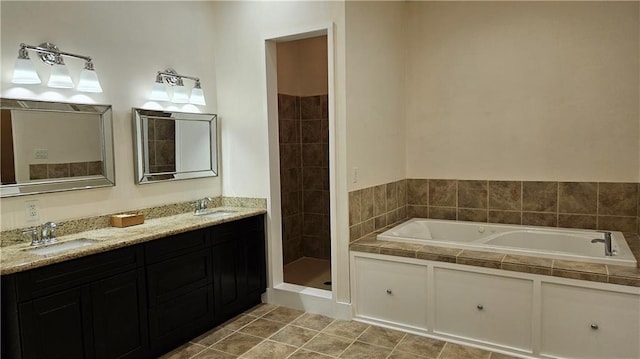 181 Latigue Rd, Avondale, LA 70094 - bathroom featuring a garden tub, double vanity, tiled shower, and tile patterned flooring