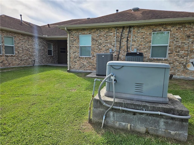 181 Latigue Rd, Avondale, LA 70094 - rear view of house featuring a yard, brick siding, and a shingled roof