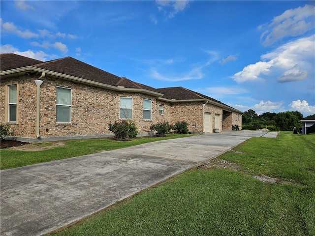 181 Latigue Rd, Avondale, LA 70094 - view of front of property featuring driveway, an attached garage, a front lawn, and brick siding