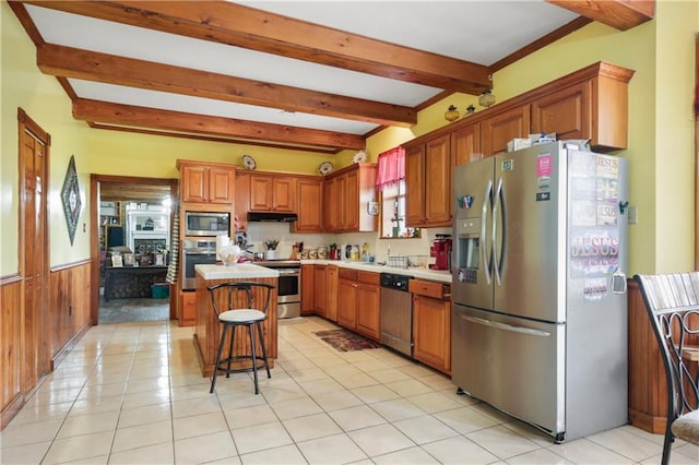 60222 N Bell Rd, Amite, LA 70422 - kitchen with appliances with stainless steel finishes, beamed ceiling, under cabinet range hood, a center island, and light countertops