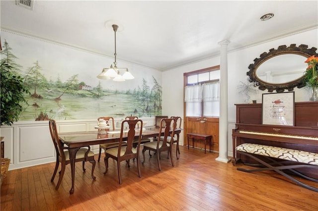 60222 N Bell Rd, Amite, LA 70422 - dining room featuring light wood-style flooring, crown molding, a chandelier, wainscoting, and ornate columns