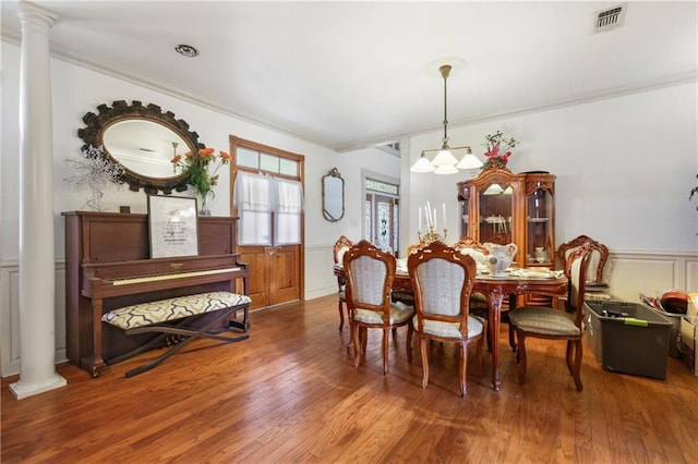60222 N Bell Rd, Amite, LA 70422 - dining room featuring ornate columns, crown molding, wood finished floors, wainscoting, and a chandelier