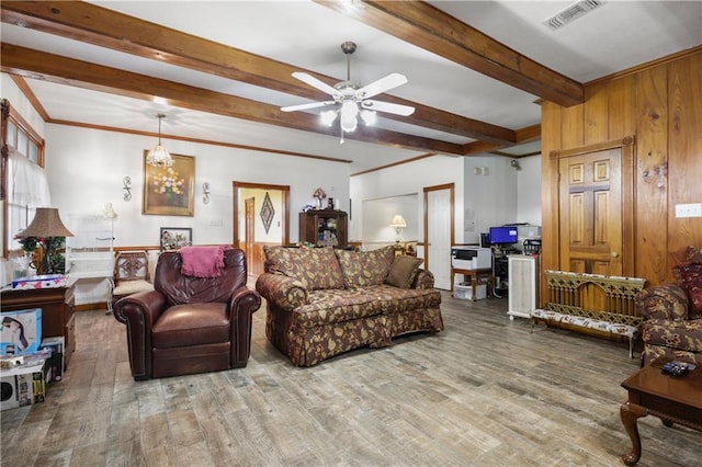 60222 N Bell Rd, Amite, LA 70422 - living area featuring beamed ceiling, a ceiling fan, wood finished floors, and wood walls