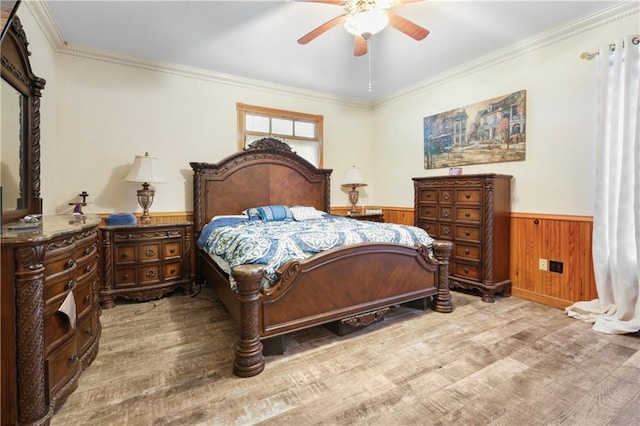 60222 N Bell Rd, Amite, LA 70422 - bedroom with wood finished floors, wainscoting, ornamental molding, wooden walls, and ceiling fan