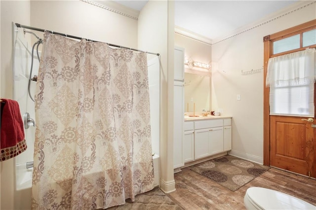 60222 N Bell Rd, Amite, LA 70422 - bathroom featuring vanity, wood finished floors, shower / bathtub combination with curtain, healthy amount of natural light, and crown molding