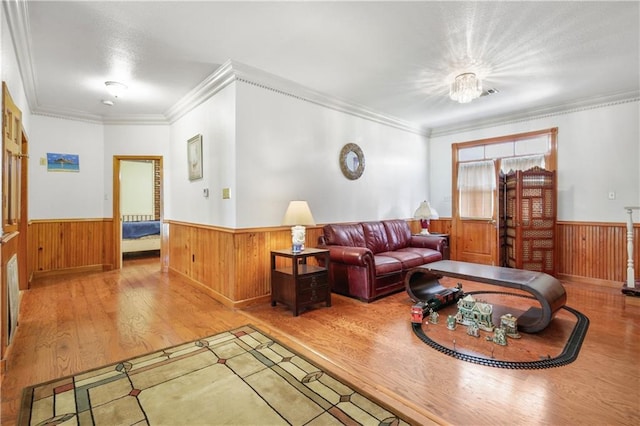 60222 N Bell Rd, Amite, LA 70422 - living room with a wainscoted wall, wood finished floors, wooden walls, and crown molding