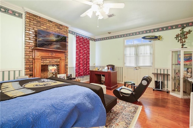 60222 N Bell Rd, Amite, LA 70422 - bedroom featuring ornamental molding, wood finished floors, a wainscoted wall, and a fireplace