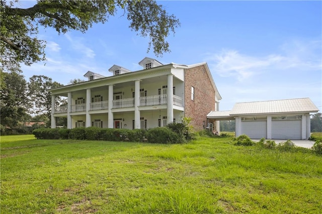 60222 N Bell Rd, Amite, LA 70422 - view of front facade featuring a front lawn, an attached garage, concrete driveway, and a balcony