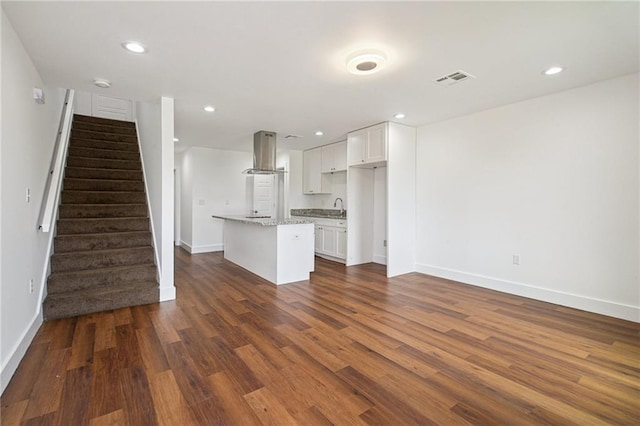 3304 Metropolitan St, New Orleans, LA 70126 - unfurnished living room featuring stairway, dark wood finished floors, and recessed lighting