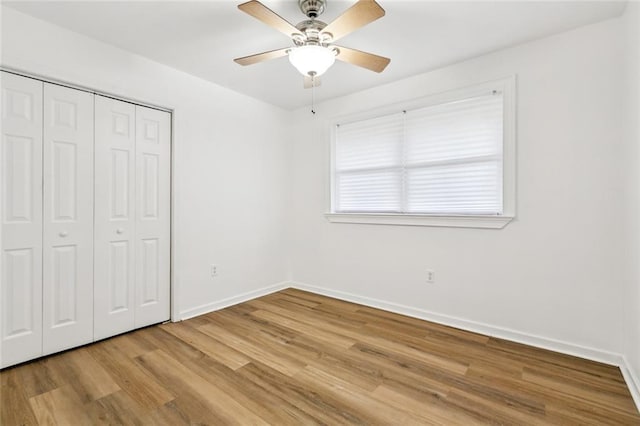 3809 N Woodlawn Ave, Metairie, LA 70006 - unfurnished bedroom with light wood-type flooring, a closet, and a ceiling fan