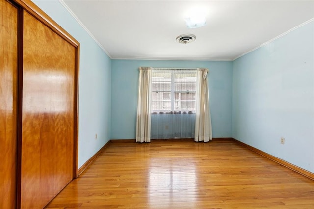 2209 Athania Pkwy, Metairie, LA 70001 - unfurnished bedroom with light wood-style floors, crown molding, and a closet