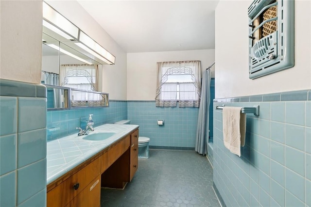 2209 Athania Pkwy, Metairie, LA 70001 - bathroom featuring tile walls, vanity, and wainscoting