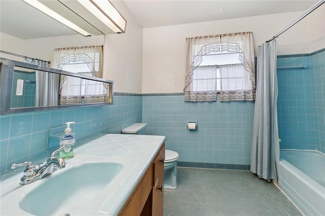 2209 Athania Pkwy, Metairie, LA 70001 - bathroom featuring tile walls, vanity, shower / bath combo, and wainscoting