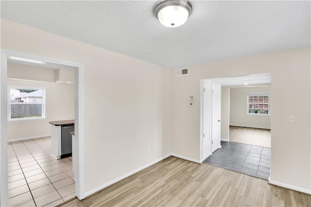 empty room featuring light wood-style floors and a textured ceiling