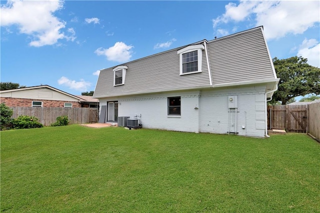 rear view of house with a fenced backyard and brick siding