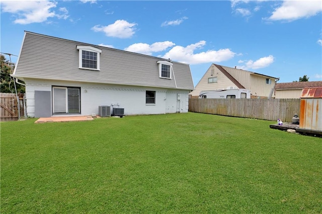 rear view of house featuring a fenced backyard and a patio area