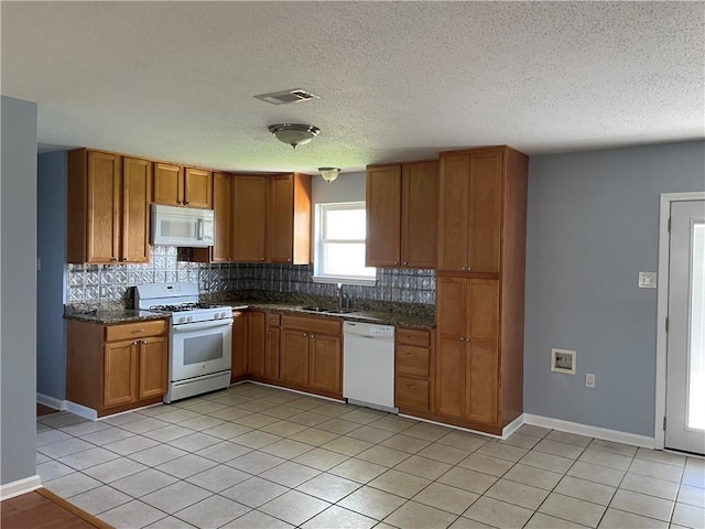 2712 Dauterive Dr, Chalmette, LA 70043 - kitchen featuring white appliances, brown cabinetry, backsplash, a textured ceiling, and light tile patterned floors