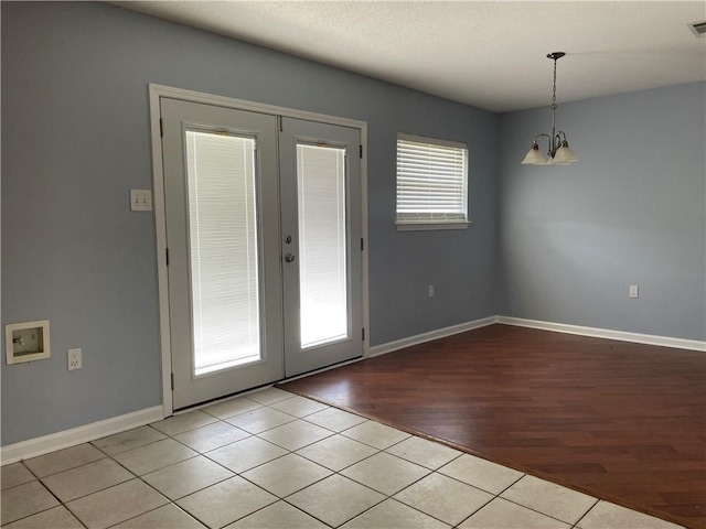 2712 Dauterive Dr, Chalmette, LA 70043 - unfurnished dining area featuring french doors, a chandelier, and tile patterned floors