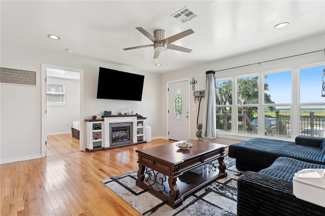 243 Carr Dr, Slidell, LA 70458 - living area with a ceiling fan, light wood-style flooring, a glass covered fireplace, and recessed lighting