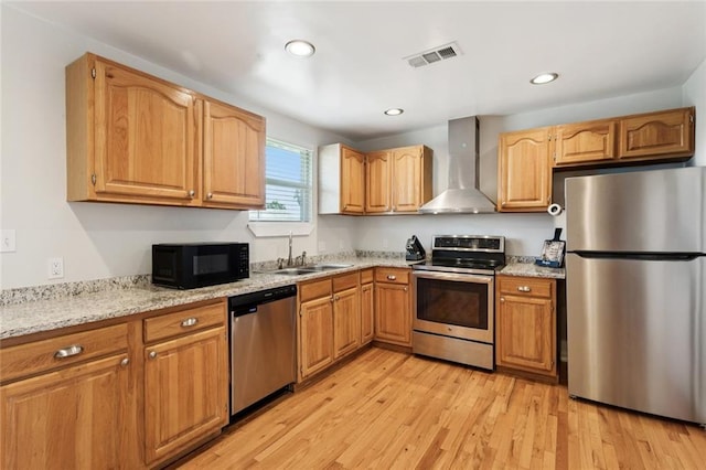 243 Carr Dr, Slidell, LA 70458 - kitchen with appliances with stainless steel finishes, wall chimney exhaust hood, light wood finished floors, light stone countertops, and recessed lighting